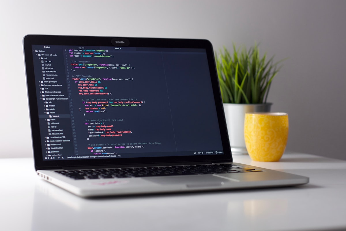 Laptop displaying code in a developer's workspace — where AI researchers and practitioners write and publish